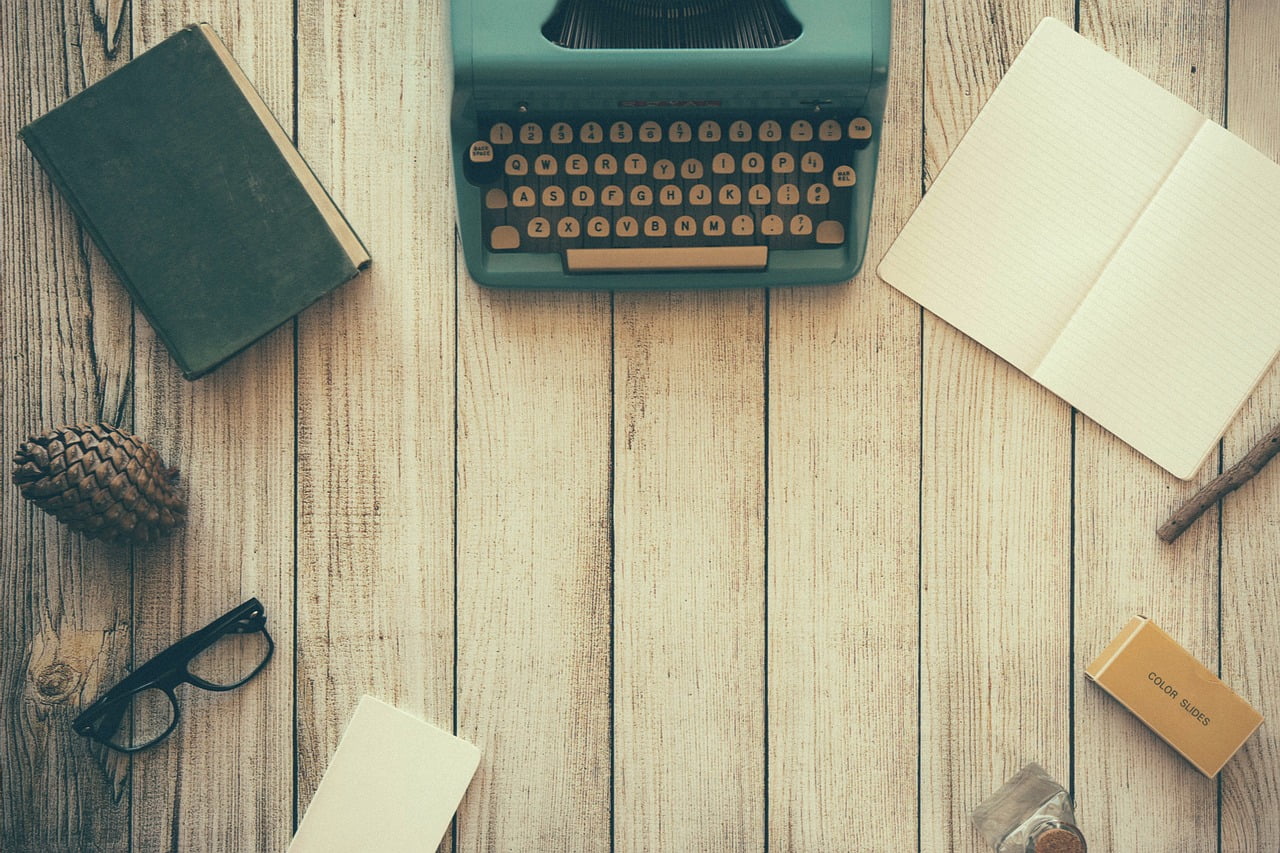 Typewriter and Some papers on Wooden table