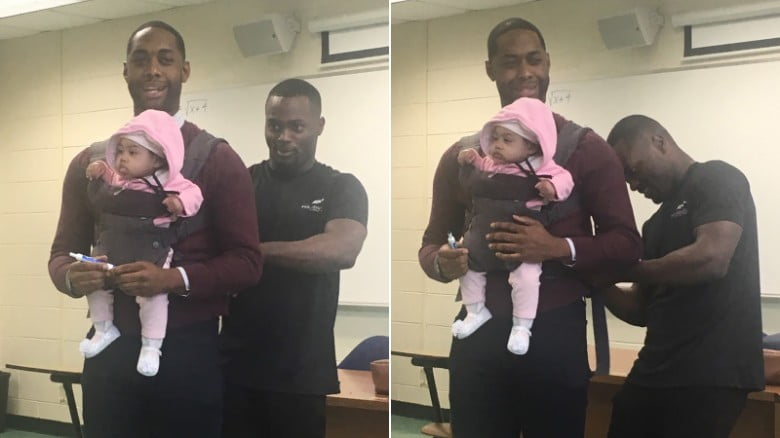 professor holding his student"s child so the student could take notes.