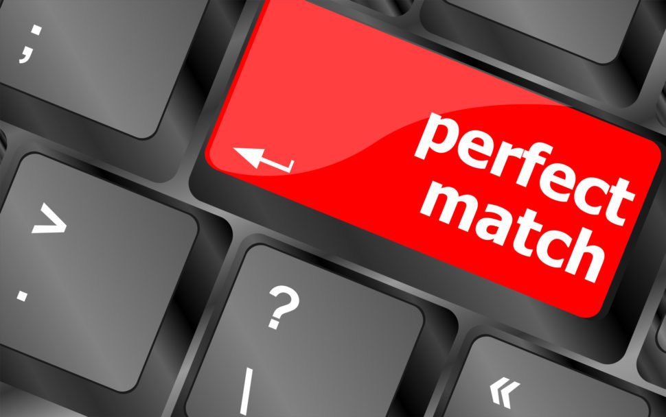 Close up of a black keyboard with a red key that reads "perfect match"