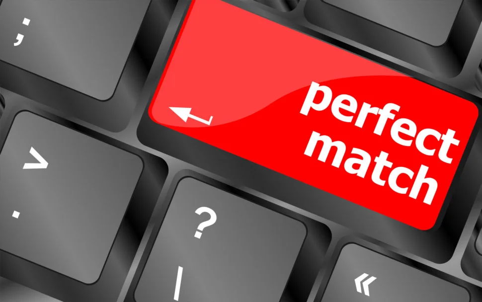 Close up of a black keyboard with a red key that reads "perfect match"