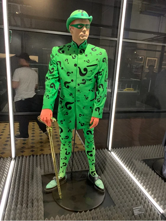 Batman's nemesis, the Riddler, dons a green costume covered in question mark.
